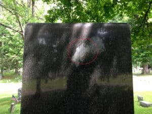 The local legend of a mysterious face of a woman showing in a white marking on a granite gravestone is shared by Chris Clemens.
