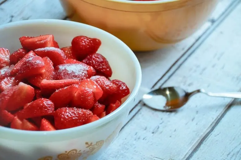 strawberries with sugar in pyrex bowls