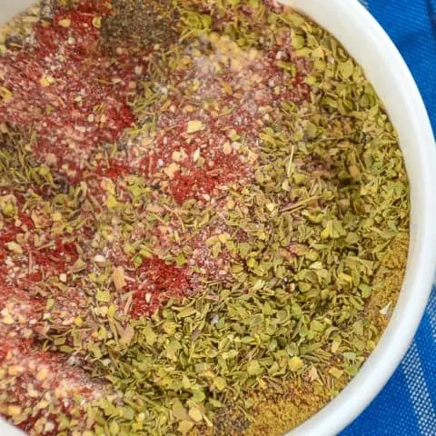Bowl of Creole Seasoning blend on a blue tablecloth