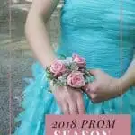 Girl in teal prom dress adusting corsage