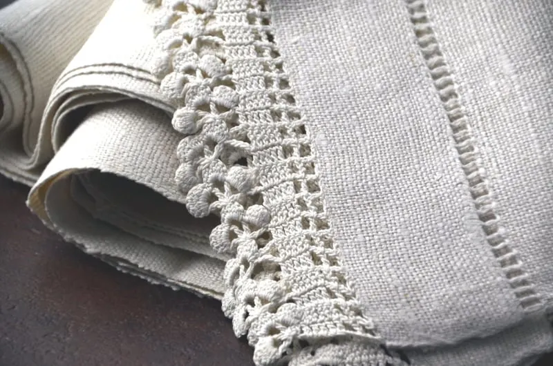 close up view of elaborate stitching on Vintage linen tablerunners 