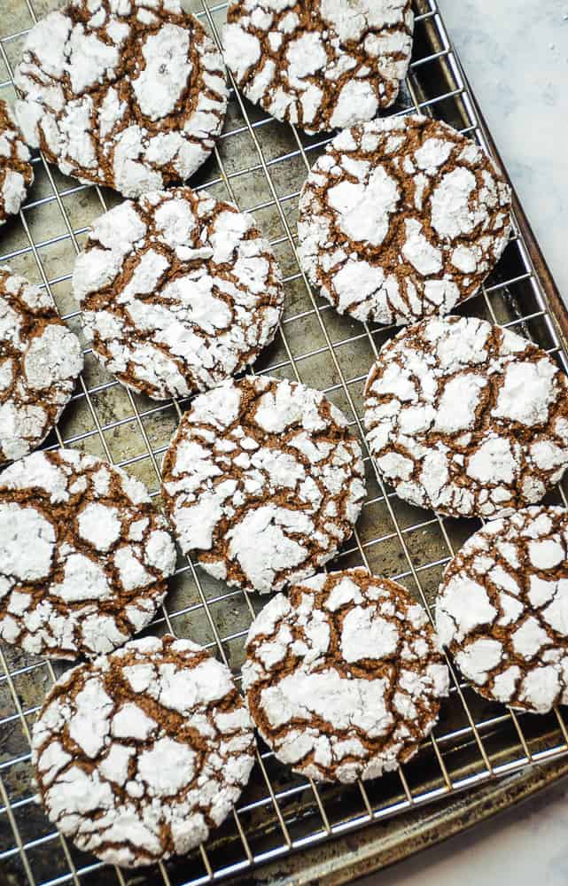 Chocolate Crinkle Cookies on a wire cooling rack. 