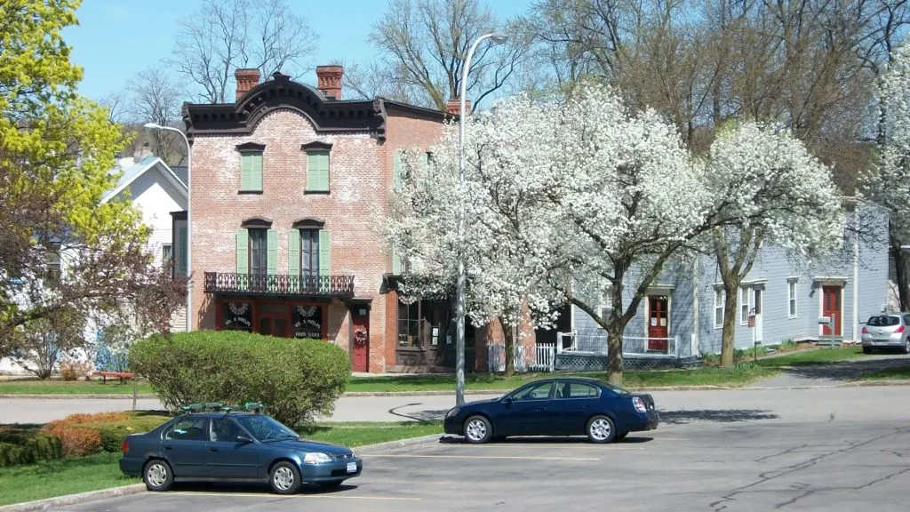 Phelps General Store and Home exterior during the spring, with surrounding flowering trees in bloom.